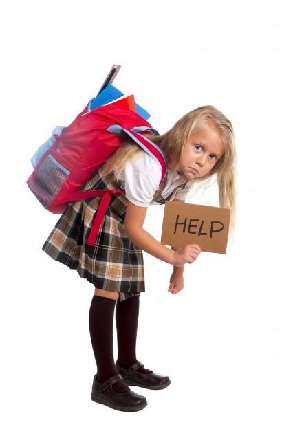 little girl carrying very heavy backpack or schoolbag full